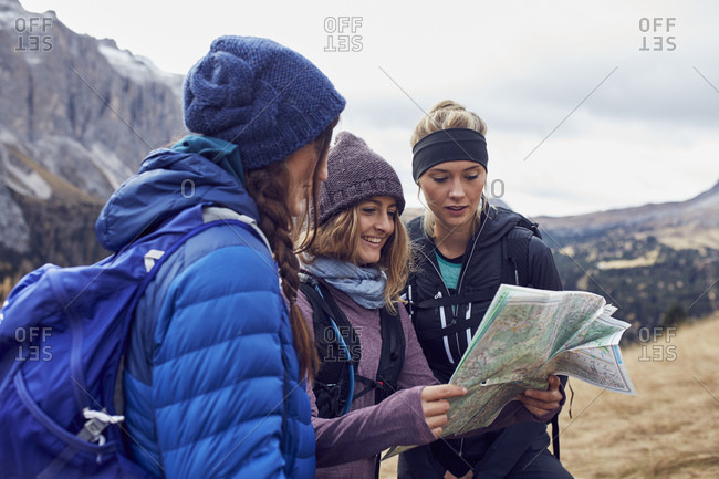 Two backpackers checking a map on a street stock photo