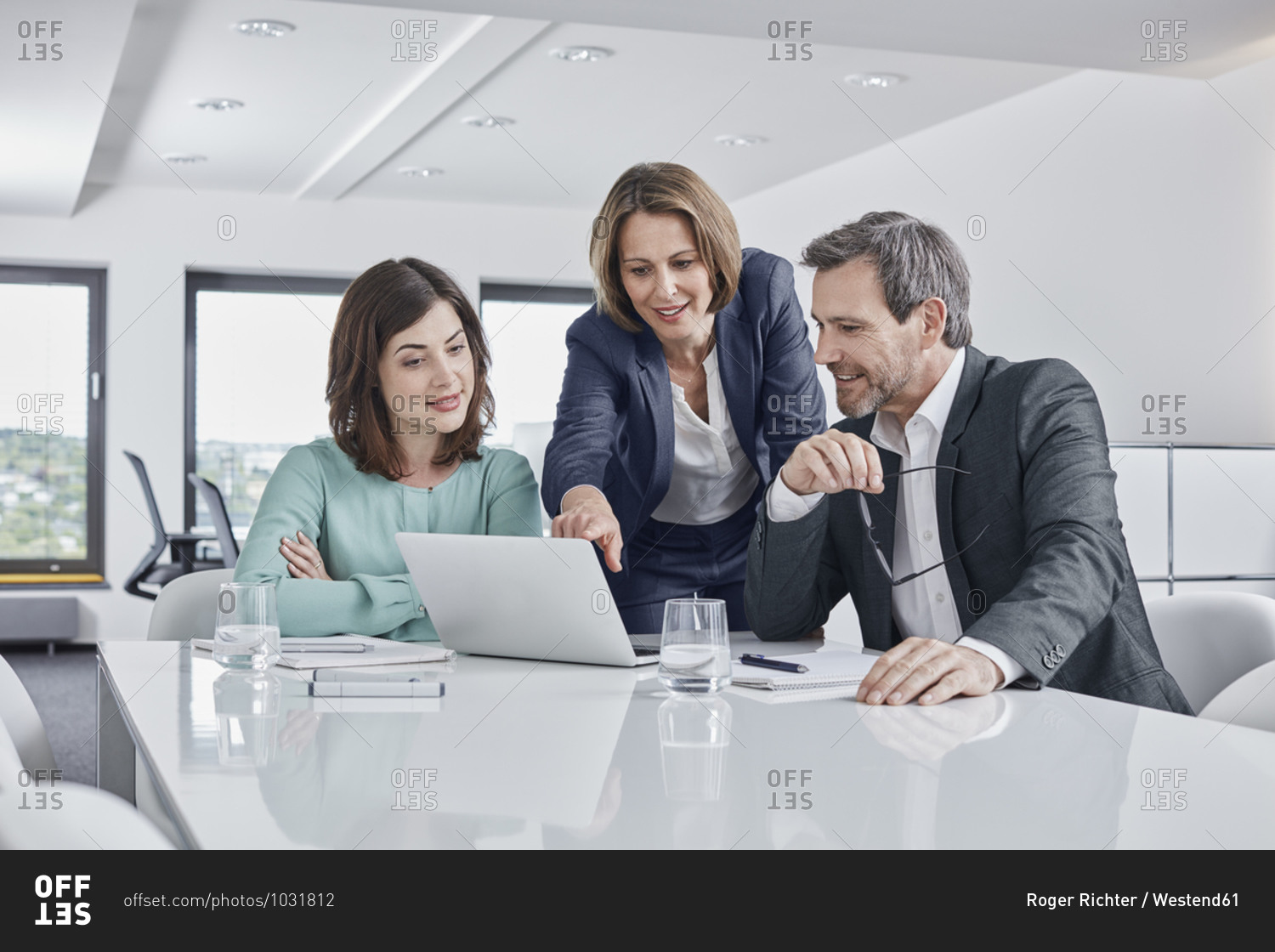 Business people having a meeting in office with laptop