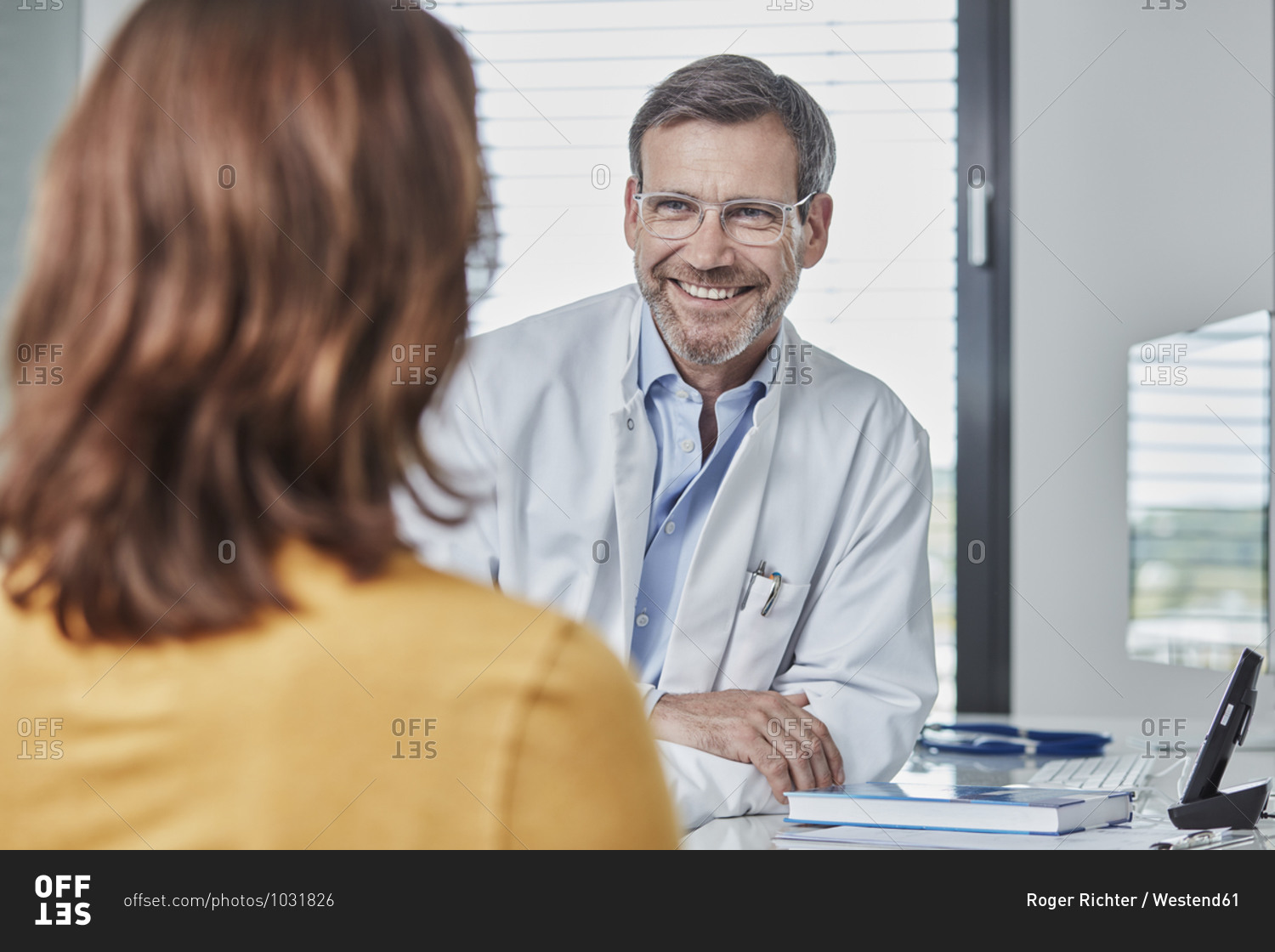 Physician and patient talking together