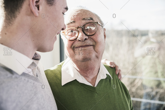 Senior man smiling at young man