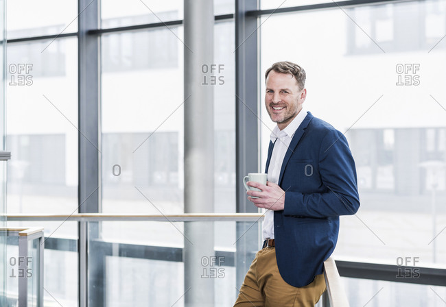 Portrait of smiling businessman having a coffee break