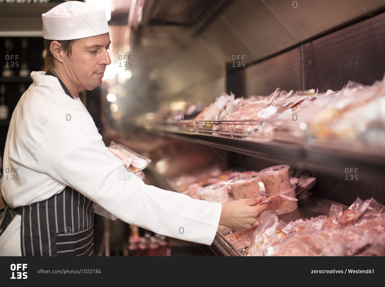 Butcher packing meat for display