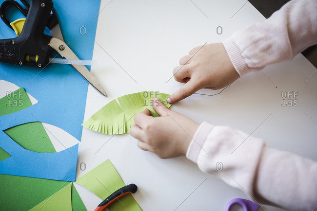 Girls hands making paper craft