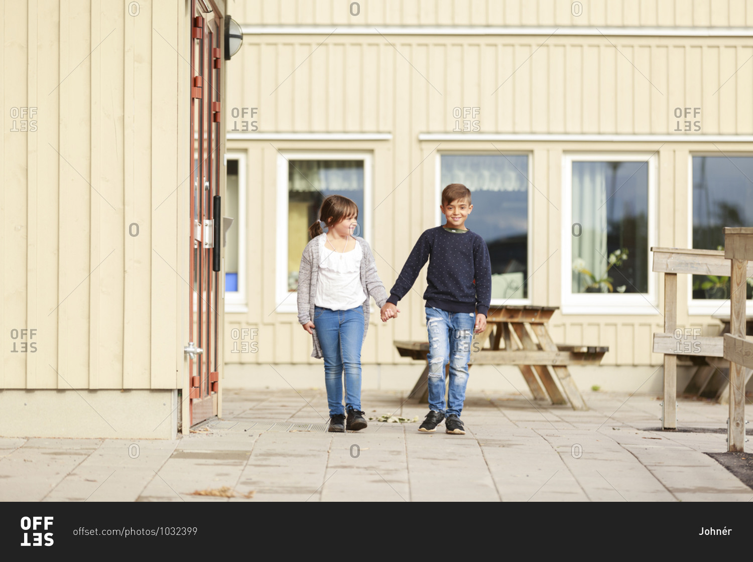 Boy and girl in front of school building