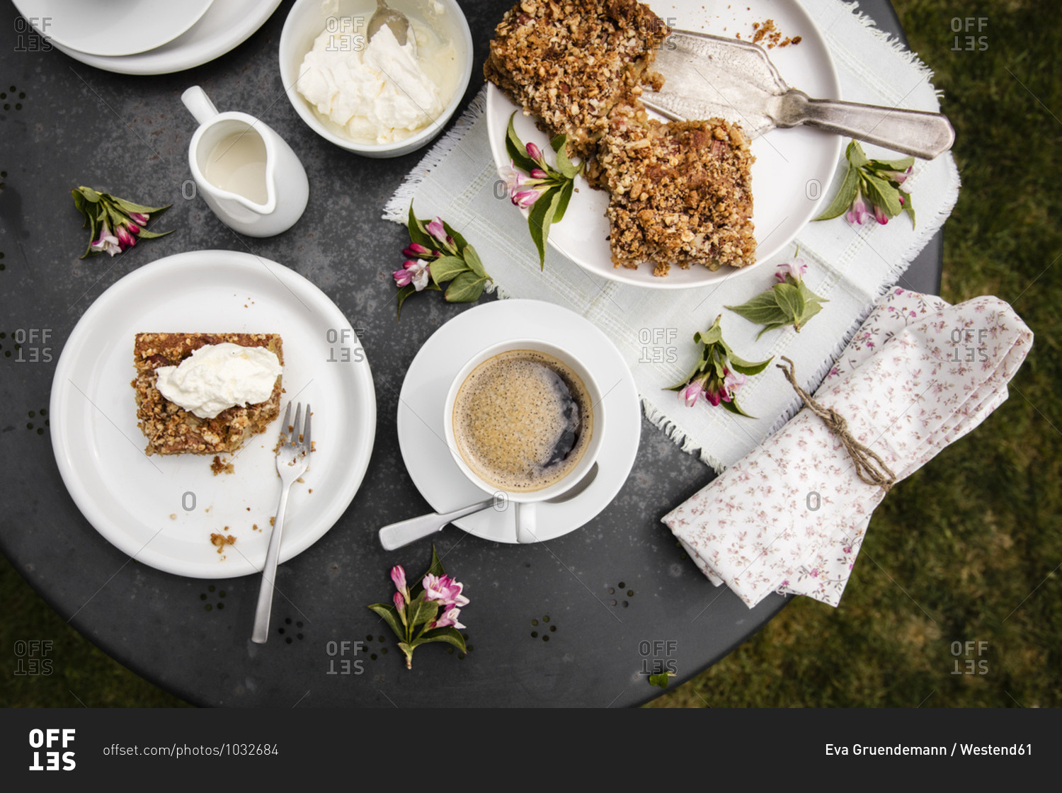 Cup of coffee and homemade rhubarb cake on garden coffee table