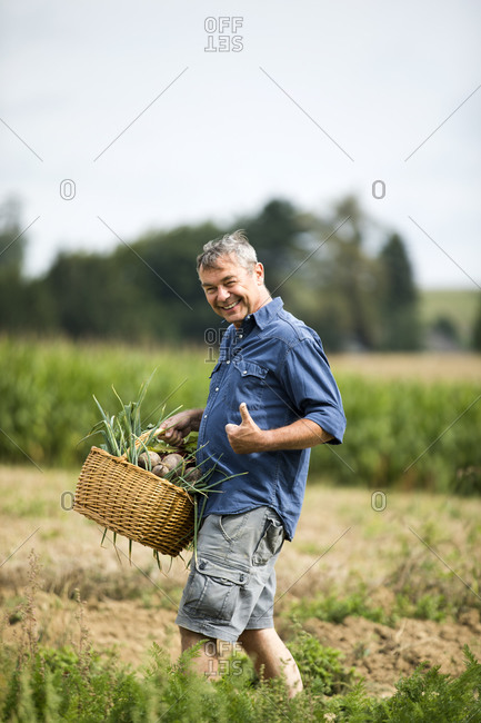 Man showing thumbs up while walking at farm