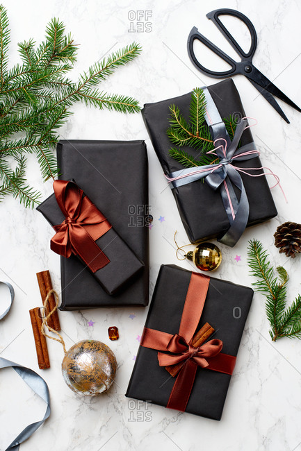 Top view of wrapped and decorated gifts and boxes with presents on marble background