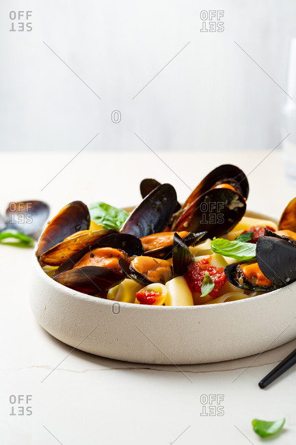 Pasta with seafood in white bowl