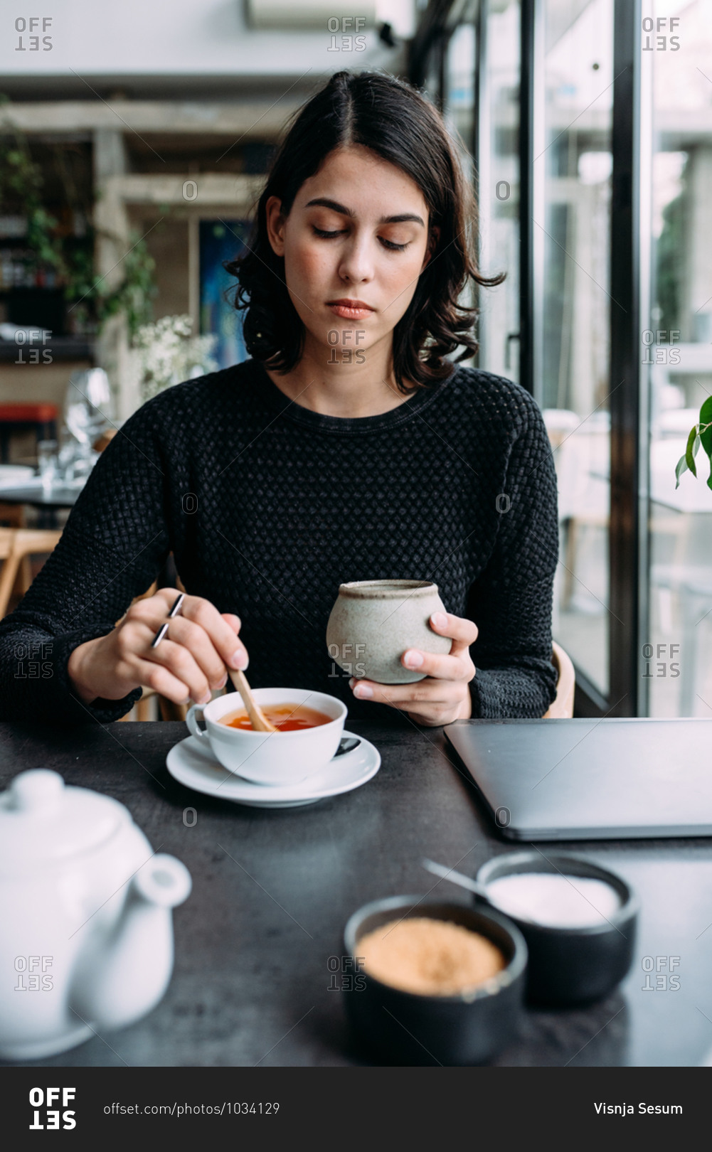 Young beautiful woman drinking tea in restaurant