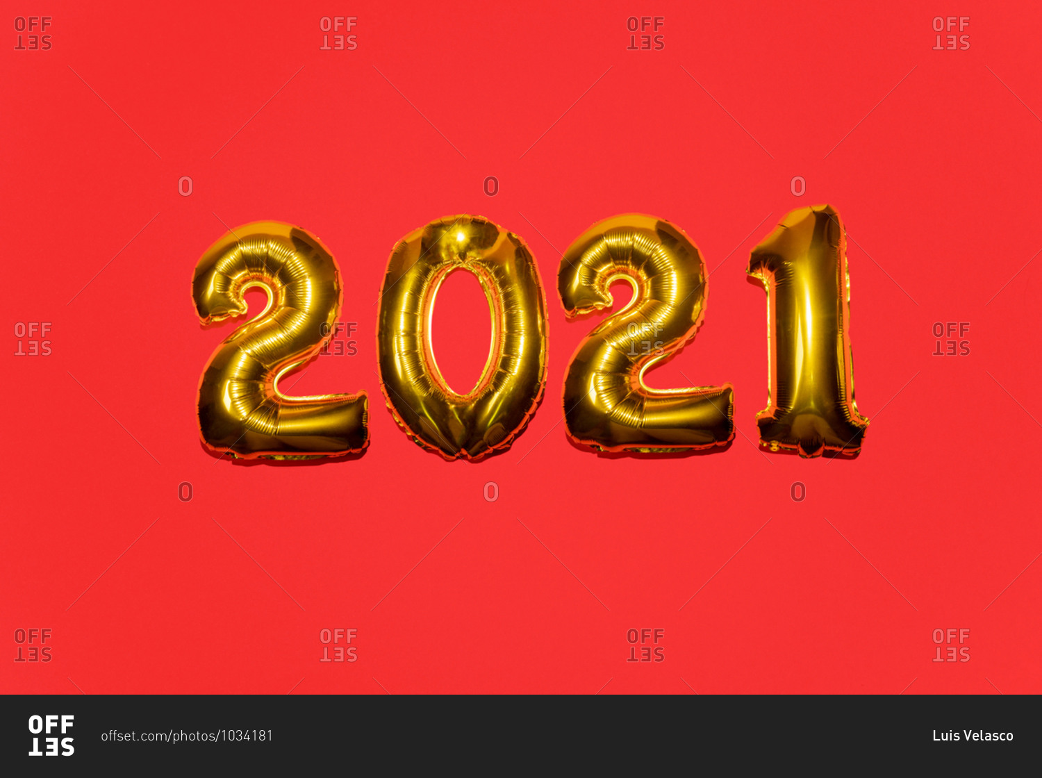 Gold mylar balloon numbers for the year 2021 on red background