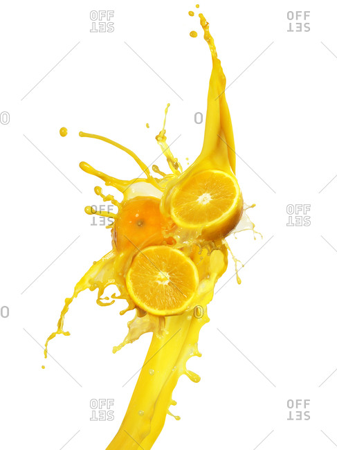 Oranges in an orange juice splash against a white background