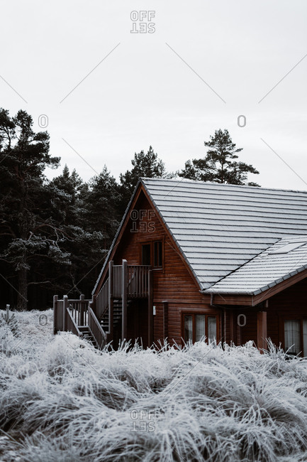 Residential cabin house with wooden facade located in village in winter in Scottish Highlands