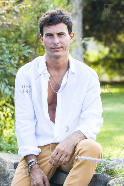Happy young male in unbuttoned white ...