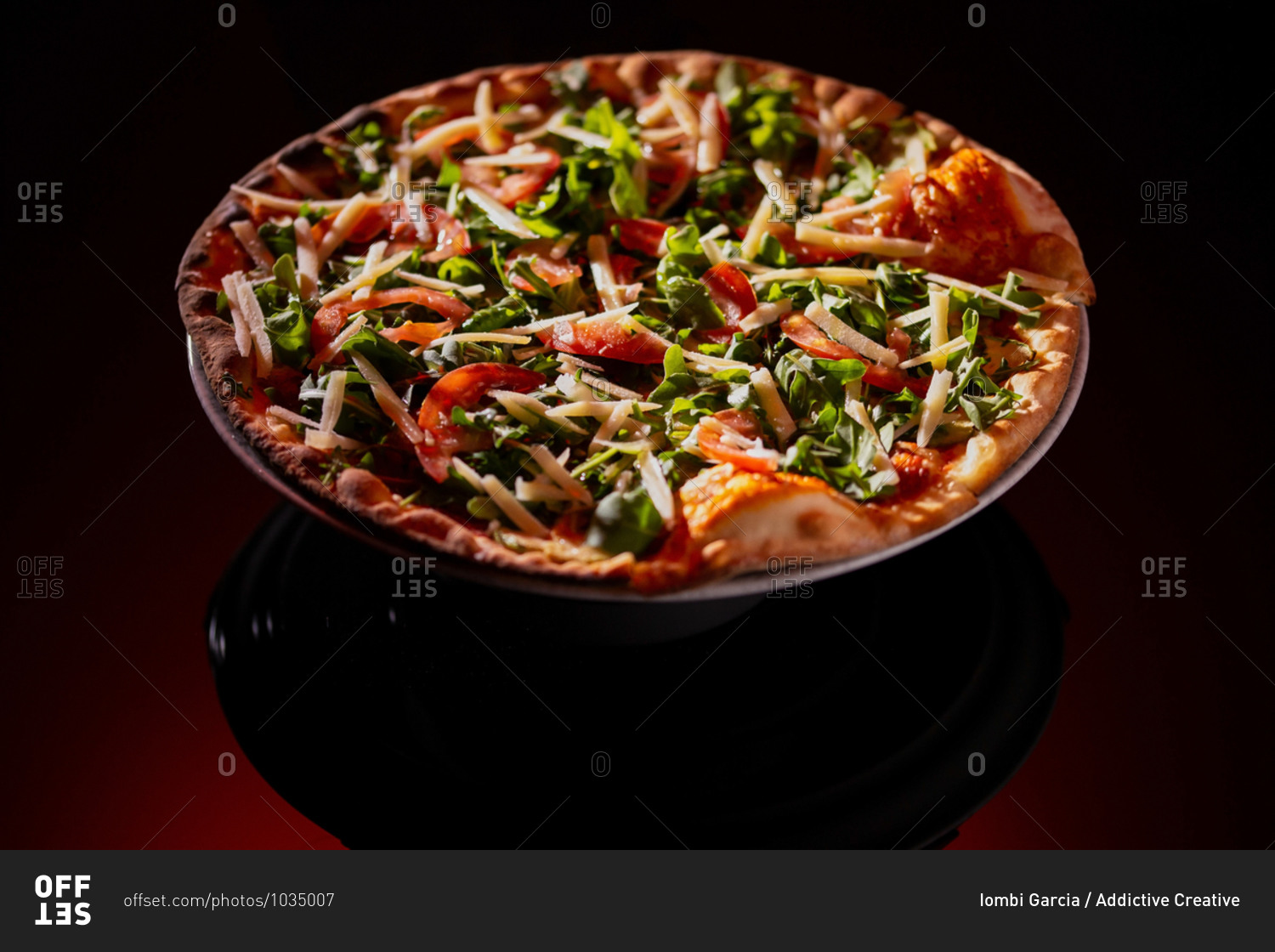 From above plate of tasty fresh pizza on dark red background