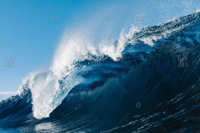 Powerful blue breaking ocean waves with white foam