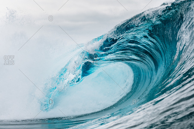 Powerful turquoise breaking ocean waves with white foam