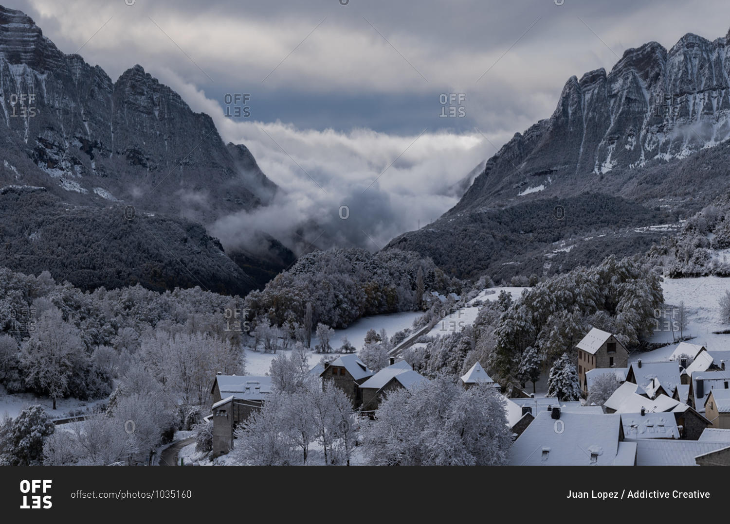 Amazing scenery of village with residential houses located in highland valley in Pyrenees in winter