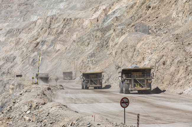 Huge dump trucks working the Chuquicamata open pit copper mine, the largest by volume in the world, Chile, South America