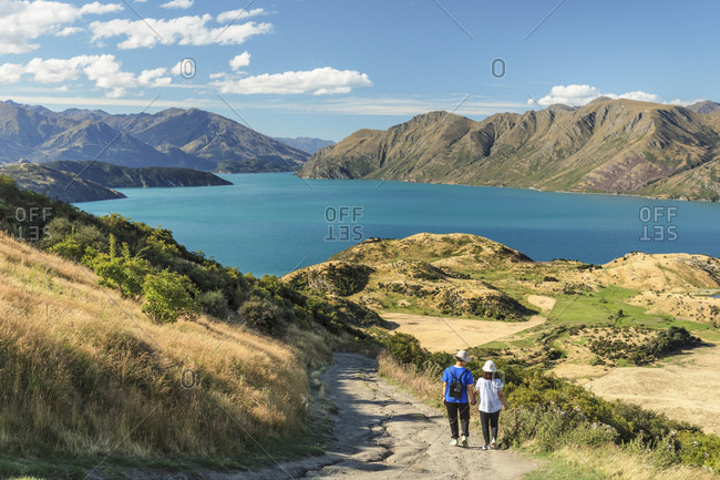 Hiker on Roy\'s Peak Track enjoying the view over Lake Wanaka, Mount-Aspiring National Park, Otago, South Island, New Zealand, Pacific