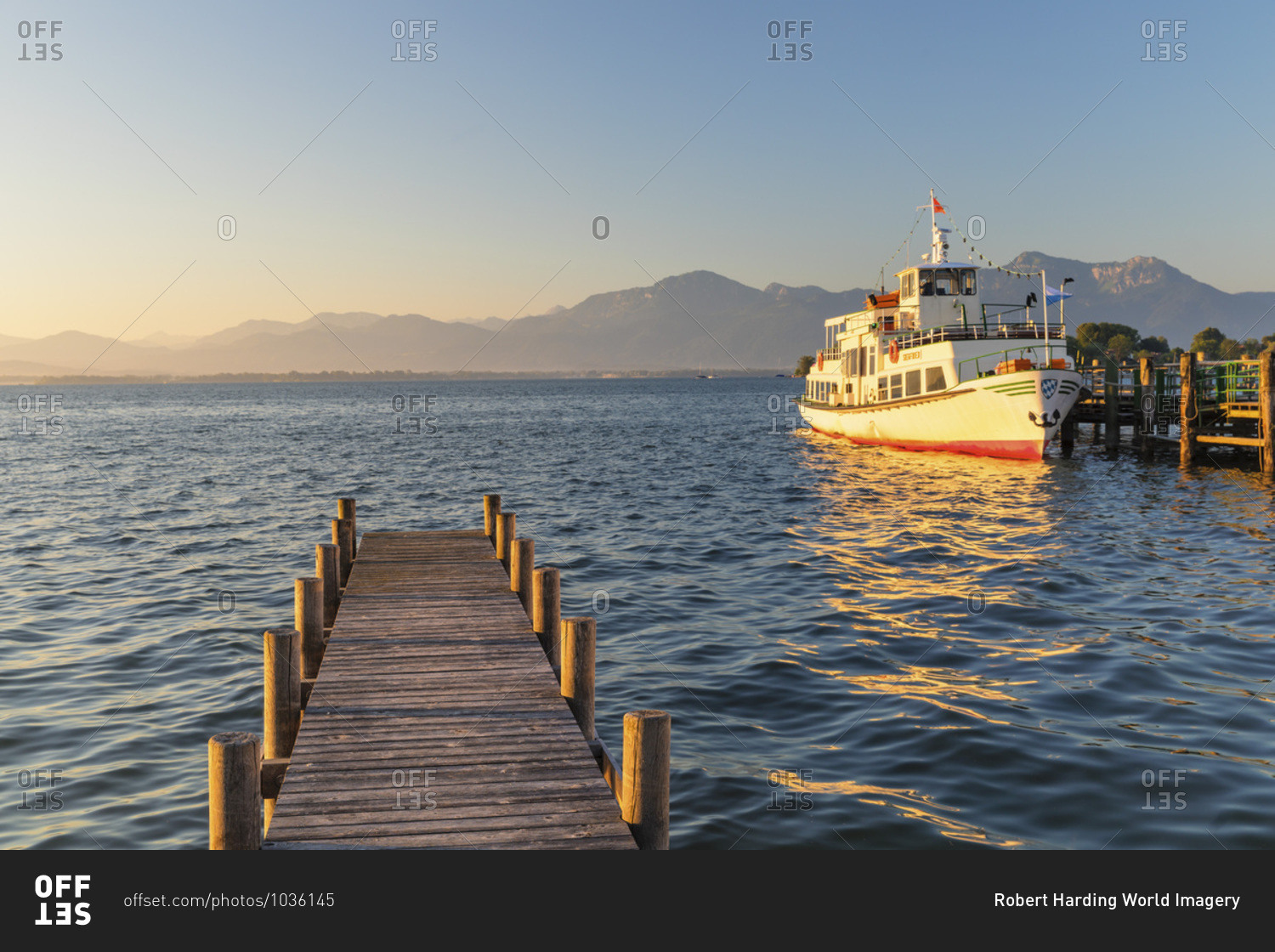 Excursion boat on a jetty at sunrise, Gstadt am Chiemsee, Lake Chiemsee, Upper Bavaria, Germany, Europe