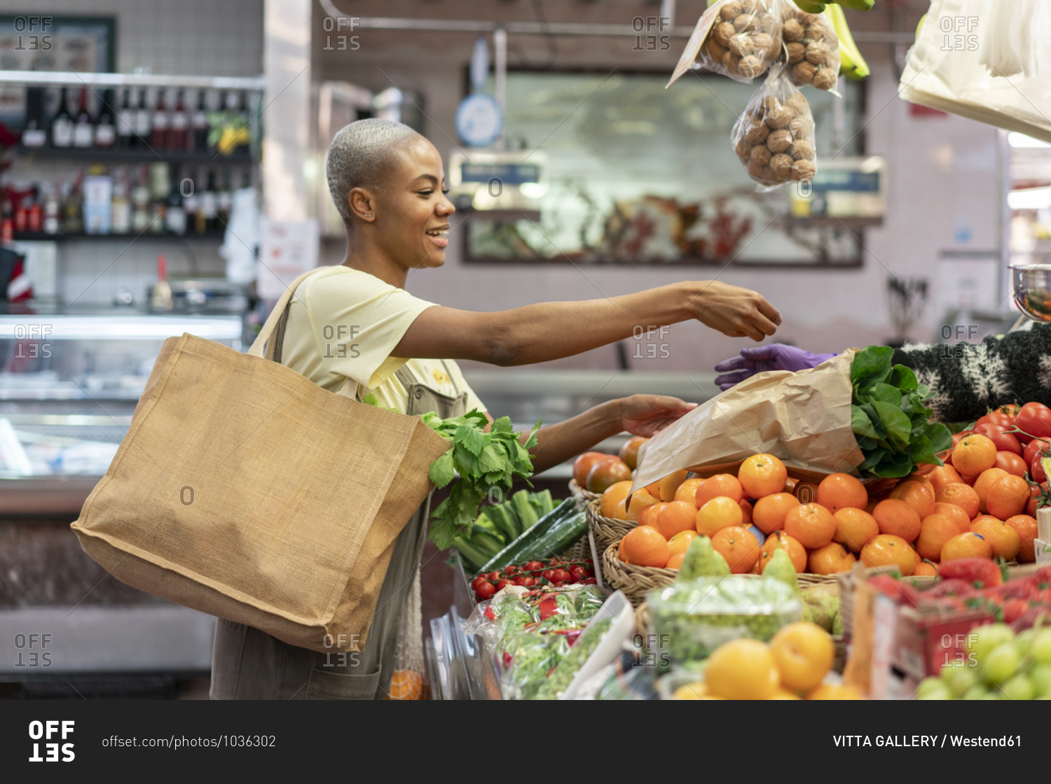 Woman buying groceries in a market hall