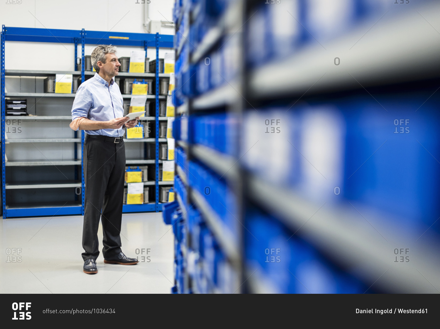 Businessman using tablet in production hall