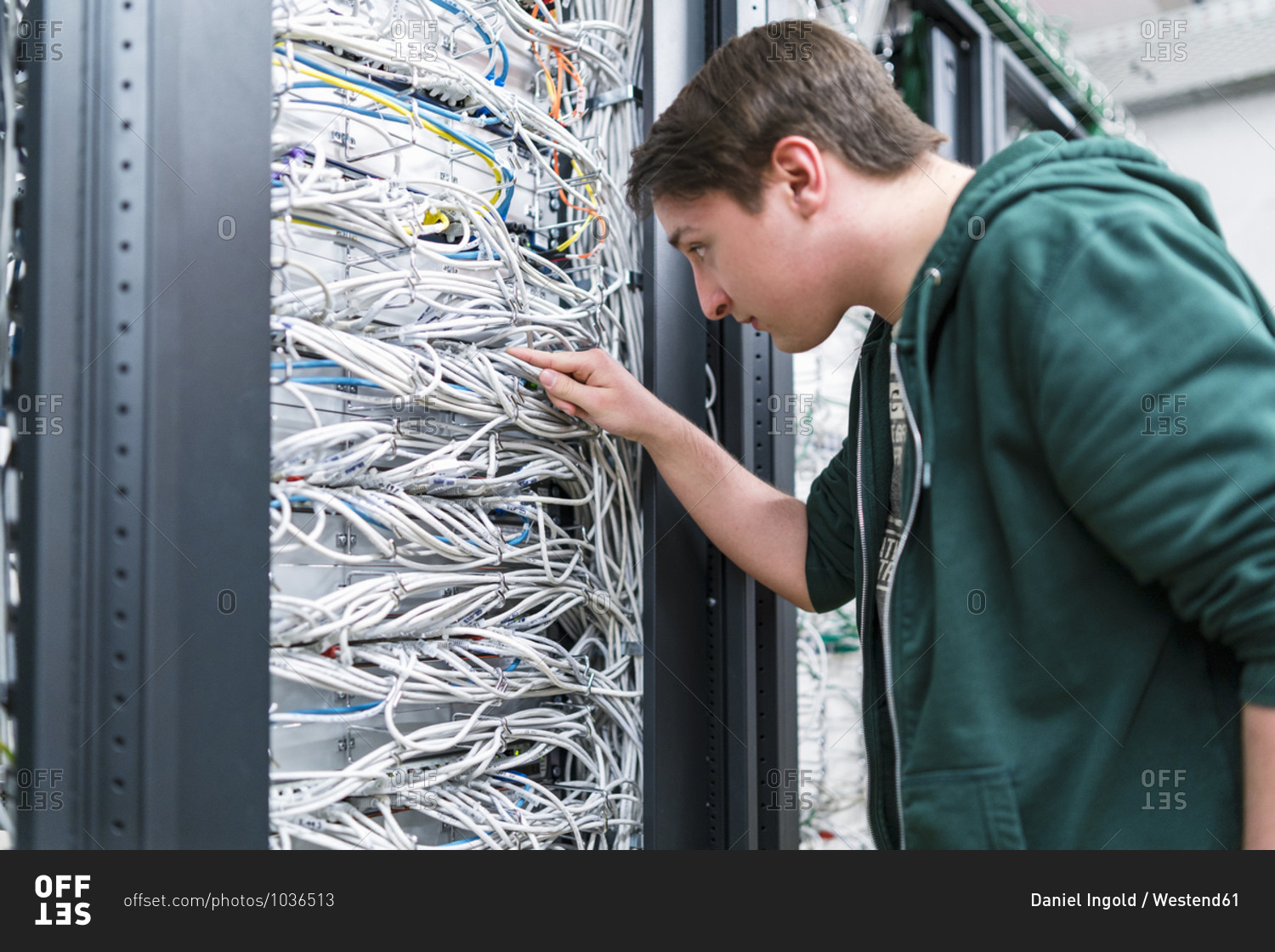 Teenager working with cables in server room stock photo -
OFFSET