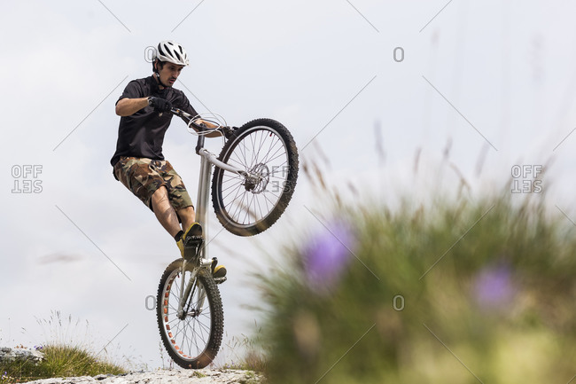 Acrobatic biker on trial bike