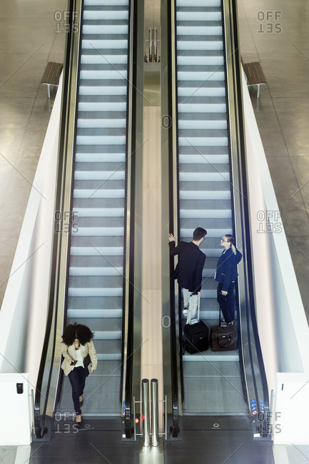 Young business people on an escalator