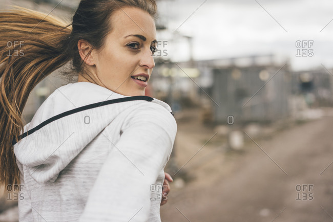 Sportive young woman running outdoors