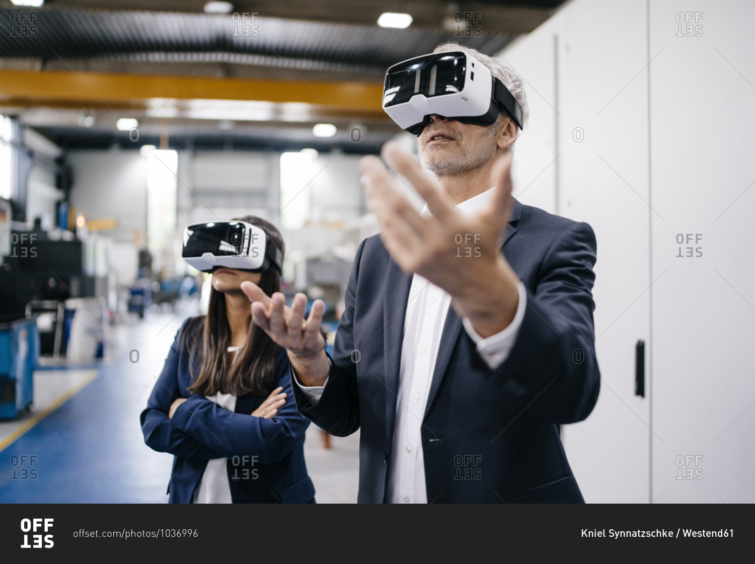 Businessman an woman in high tech enterprise- using VR glasses