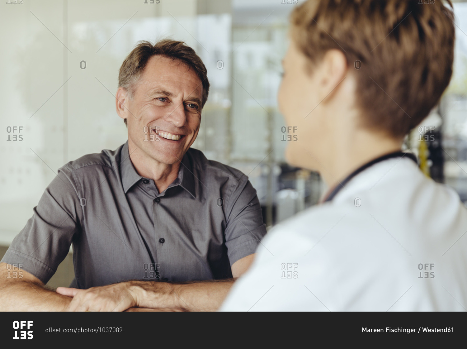 Female doctor talking to patient in practice