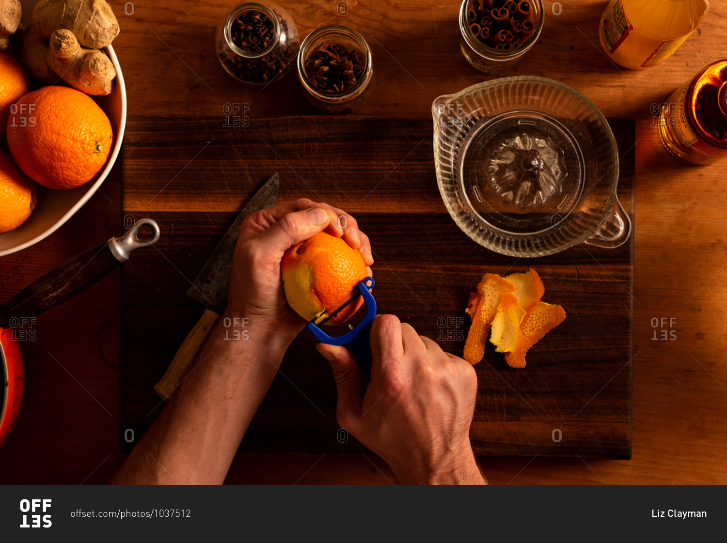 Peeling an orange for a mulled apple cider and orange cocktail
