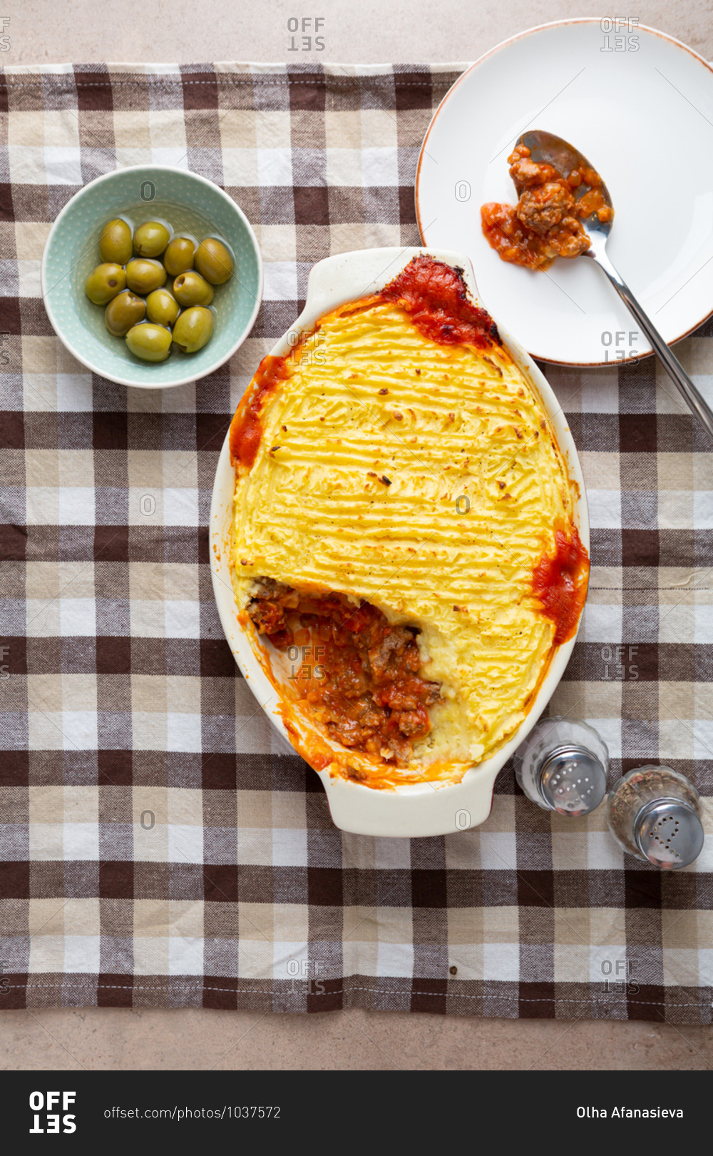 Overhead view of big family dish of shepherds pie being served