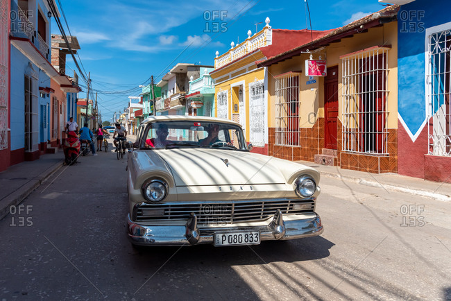 August 26, 2019: Street scene with an old American car on the cobblestone street. Trinidad, Cuba