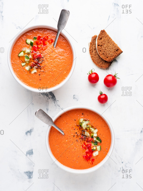 Gazpacho vegetarian soup with fresh cucumber bell pepper and garlic on white background. Spanish cuisine