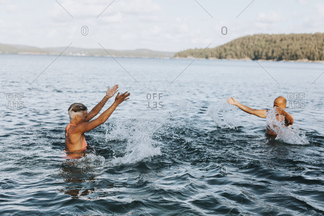 Couple splashing each other in sea