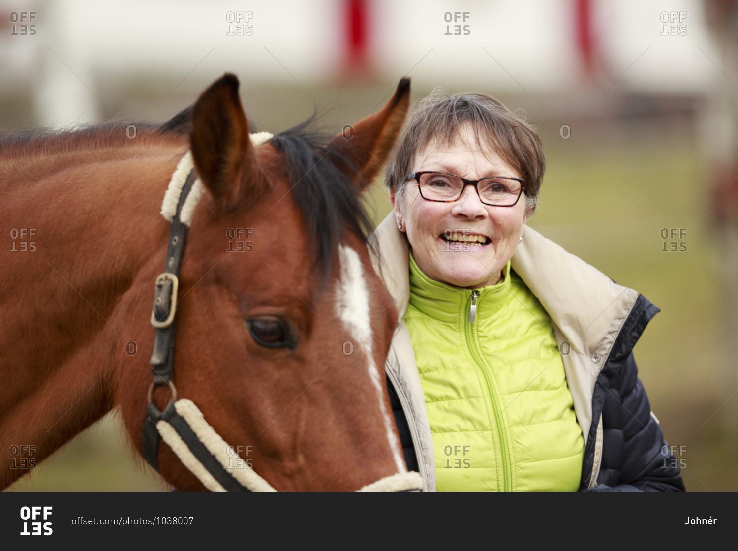 Smiling woman with horse. Detailed shot.