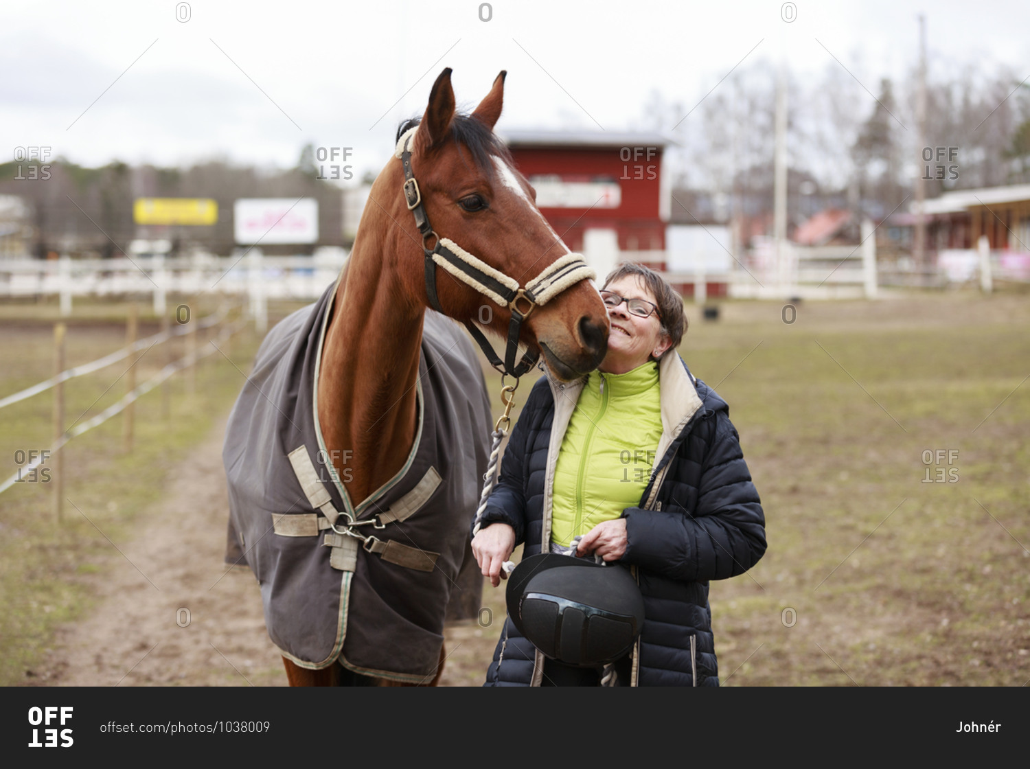 Smiling woman with horse. Detailed shot.