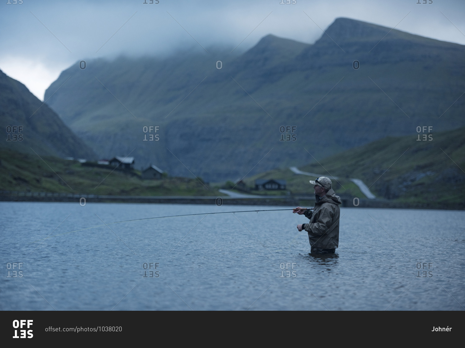 Man fly fishing in lake. Detailed shot.