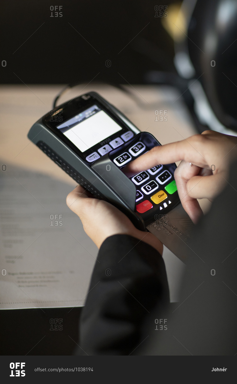 Close-up of hands holding credit card reader