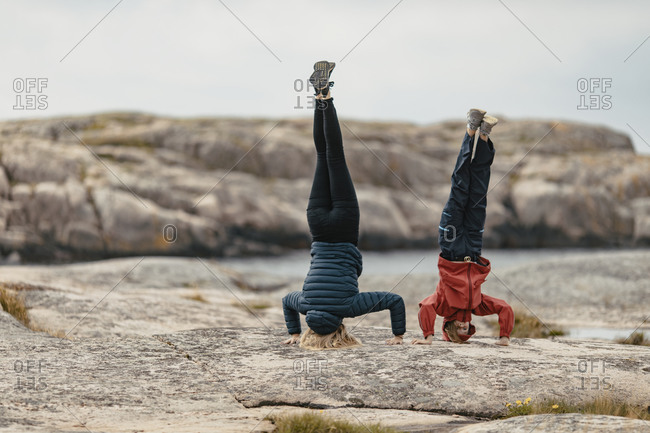 Mother and daughter doing handstand. Detailed shot.