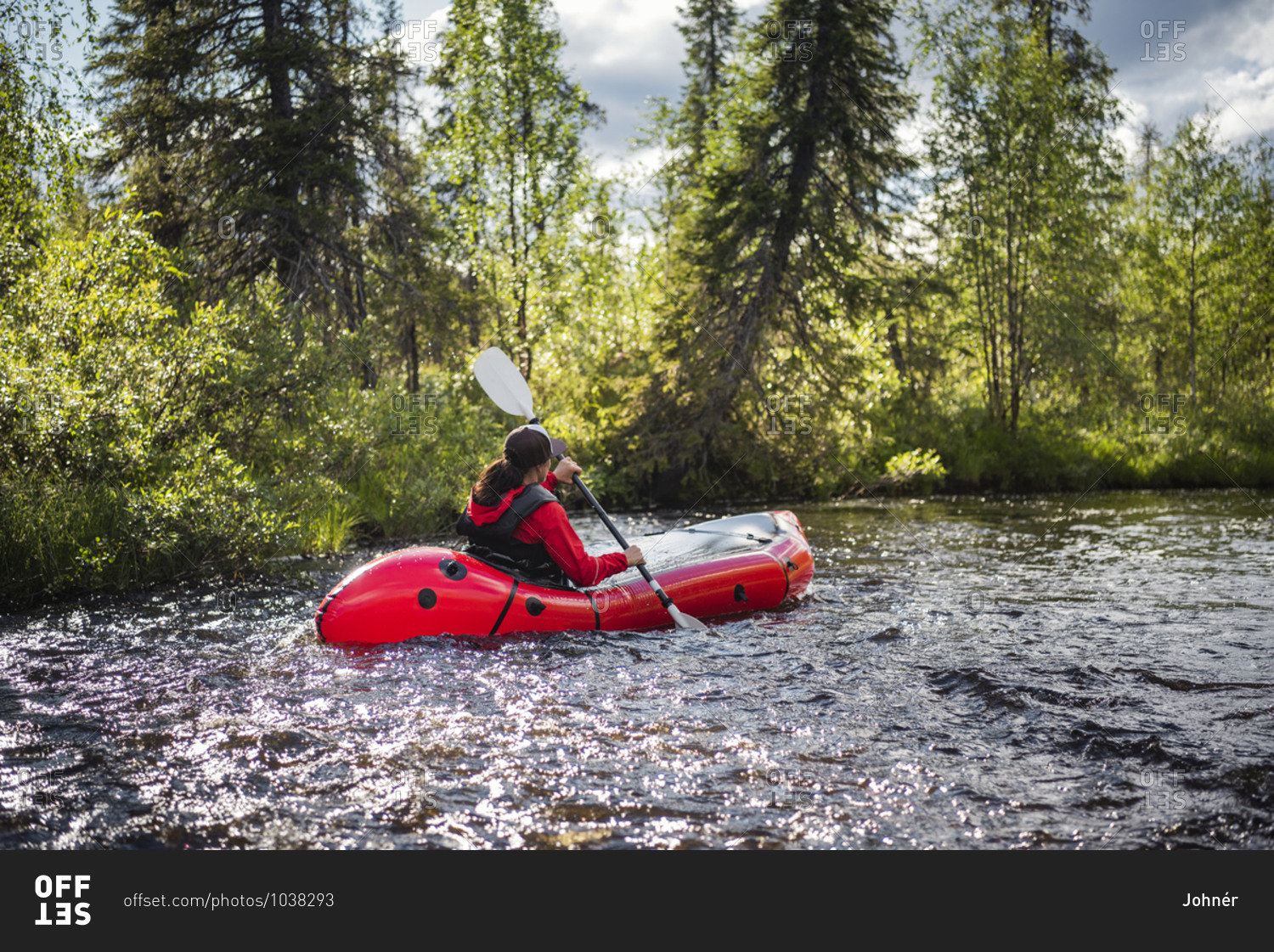Woman kayaking on river. Detailed shot.