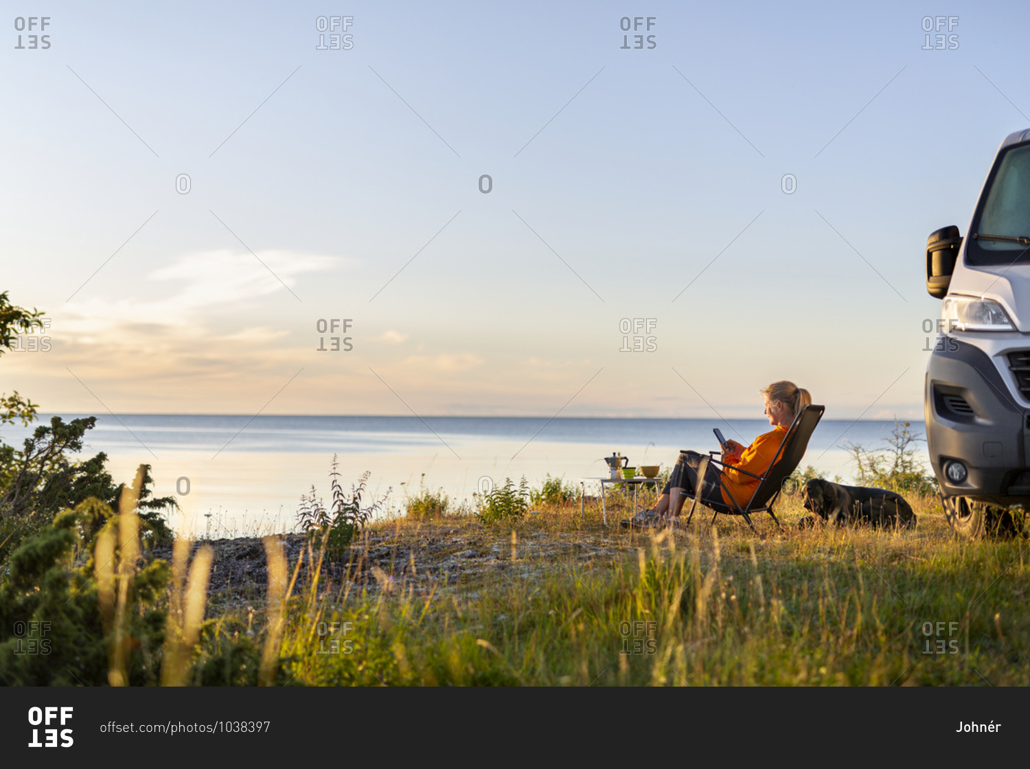 Woman relaxing on lounge chair at sea