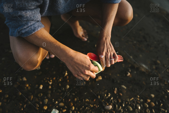 Womans hands washing cutlery. Detailed shot.