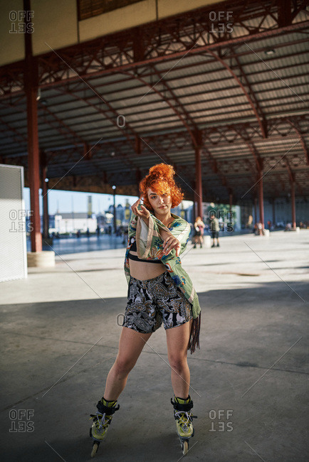 Young alternative redhead girl roller skater