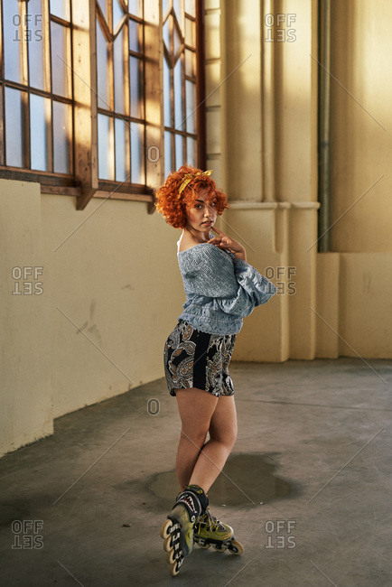 Young alternative redhead girl roller skater