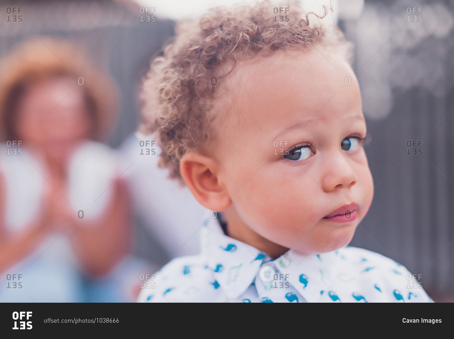 Mixed race baby boy with blue eyes looking at camera stock photo - OFFSET