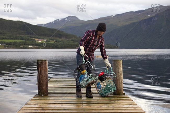 A fisherman collecting his crab pots on a fjord in Norway