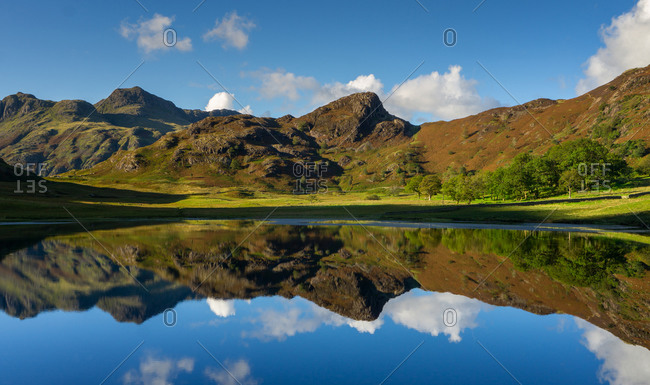 Reflections of the Langdales in Blea Tarn in the English Lake District, UK